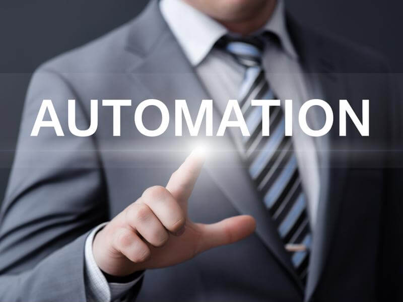 Person in a suit pointing to AUTOMATION graphic 